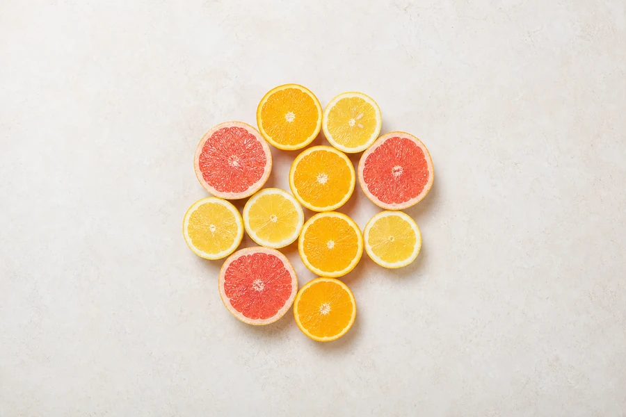Citrus fruits cut in half, arranged in a circle, seen from above