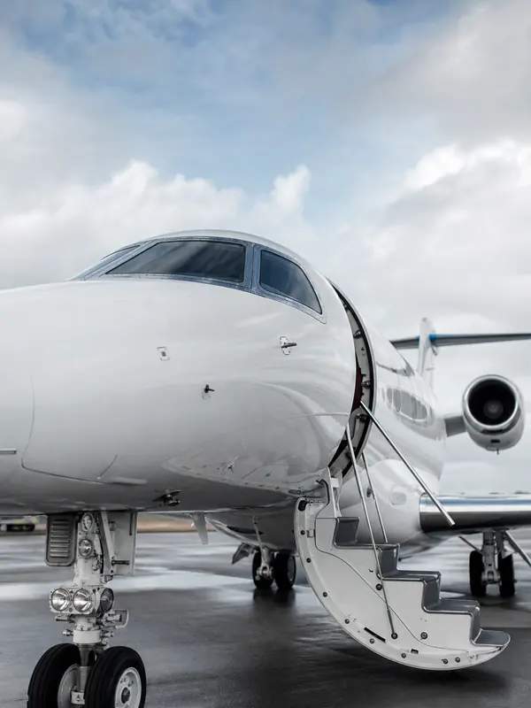 A private jet with its door open, ready for departure