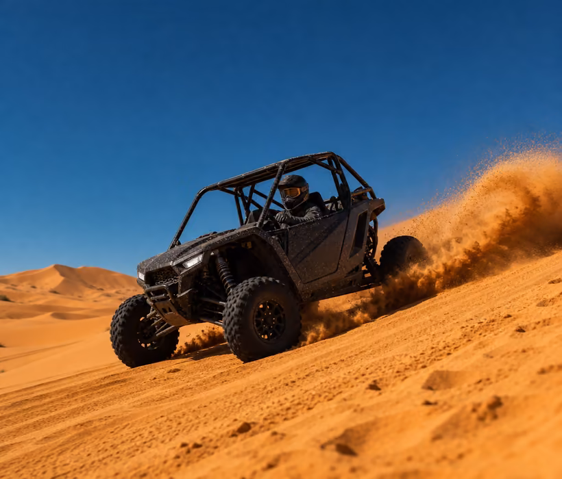 Dune buggy driving through Sahara sand dunes.