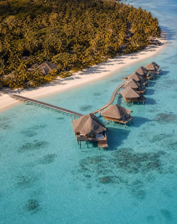 Aerial view of Maldives overwater villas and turquoise lagoon.