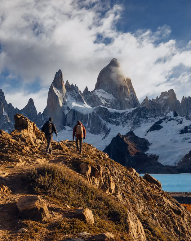 Hikers trekking near Patagonia glaciers and mountains.