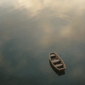 A small boat on a wide, still sea.