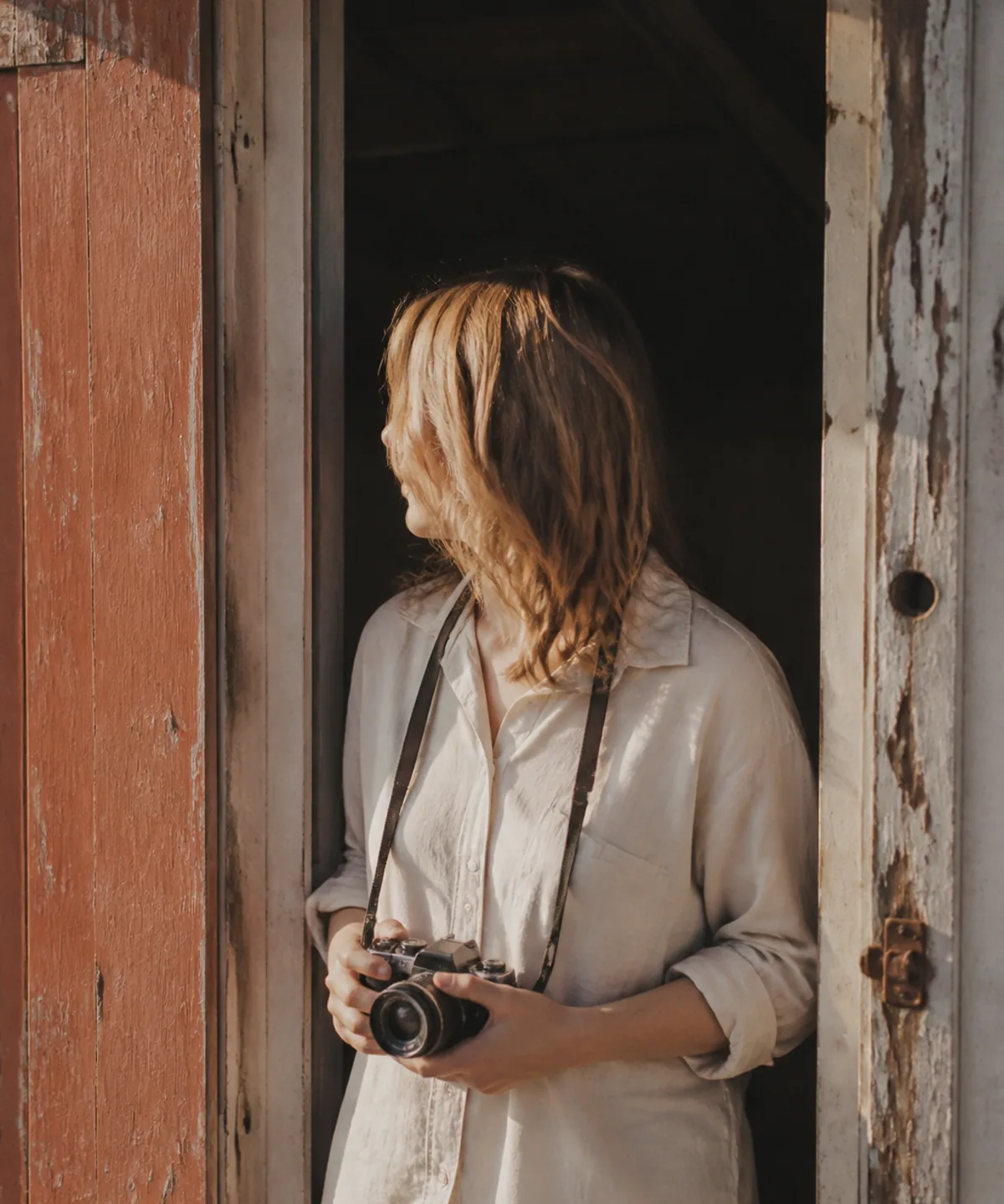 The photographer in a doorway, looking out towards the light.