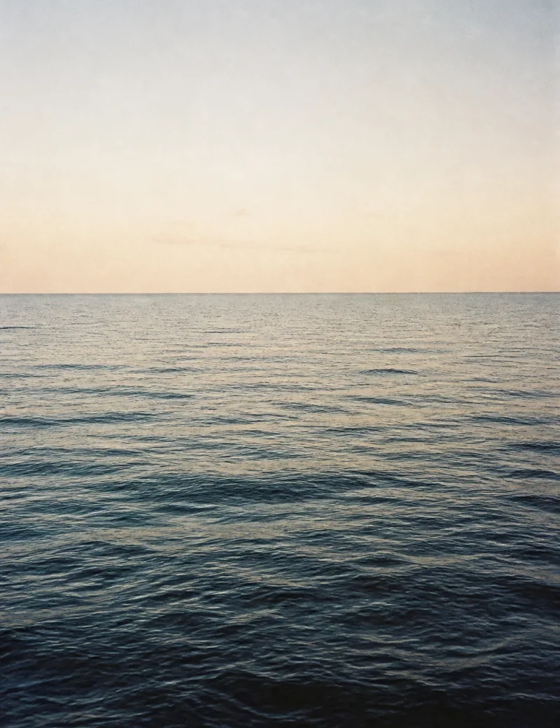 Deep blue open water meeting a pale horizon.