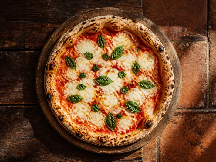 A margherita pizza fresh out of the wood-fired oven.