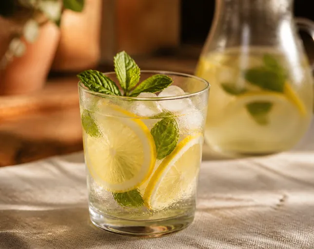 Lemonade with lemon slices, mint and ice.