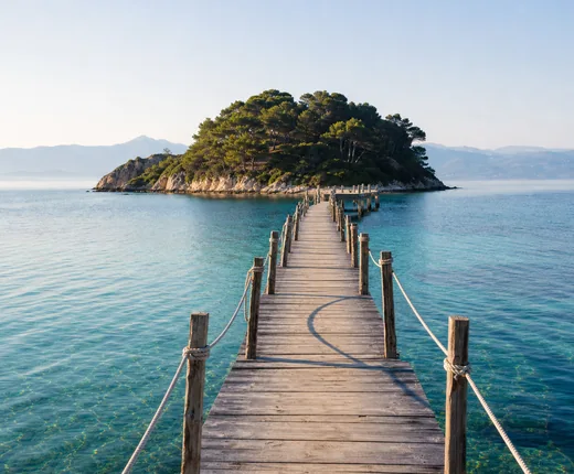 Wooden pier reaching into a turquoise bay