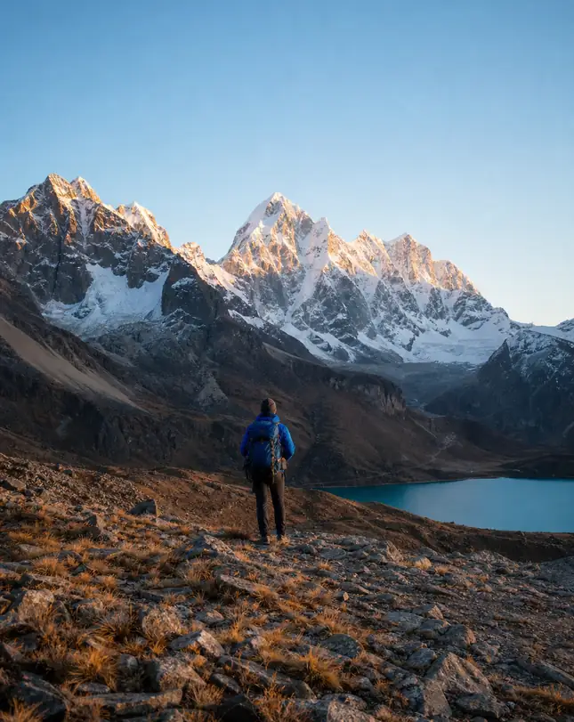 Lone trekker on a high pass at golden hour