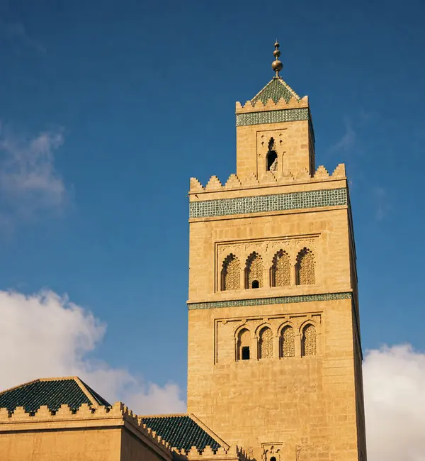 Mosque with green roofs under a blue sky