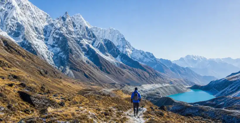 Lone trekker crossing a high mountain pass