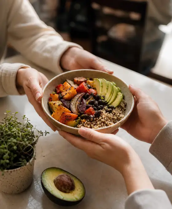 A grain bowl being handed over