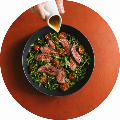 Olive oil poured over a beef salad